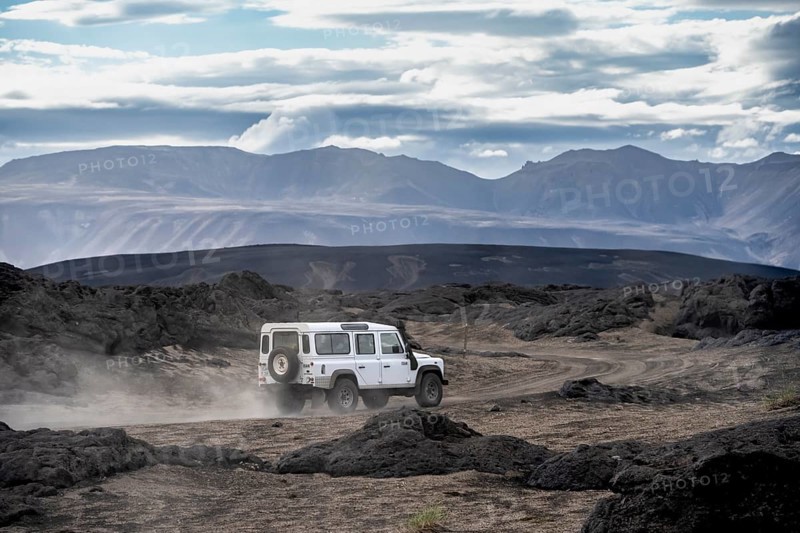White Land Rover on a dirt road