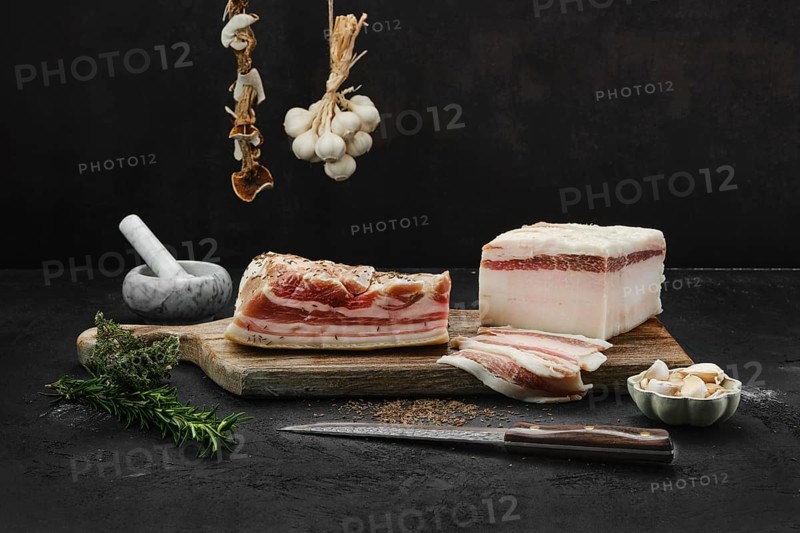 Two types of salted pork belly lard on cutting board