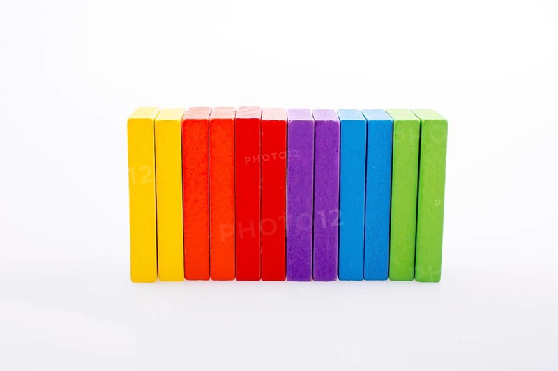 Colorful Domino Blocks in a line on a white background