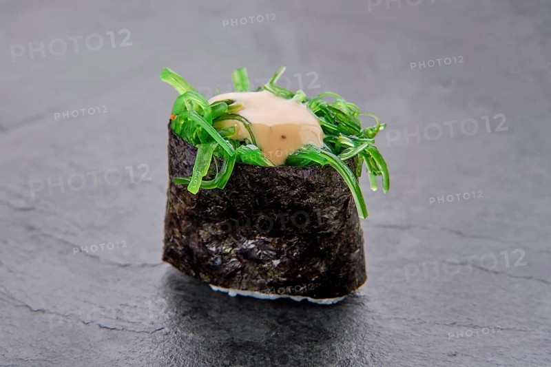 Macro photo of pickled seaweed with nut sauce