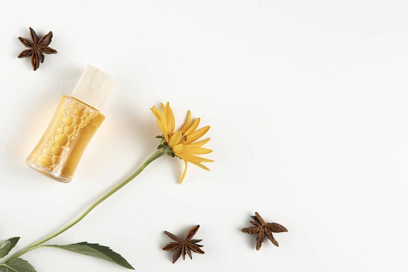 Close up view anise stars essential oil bottle