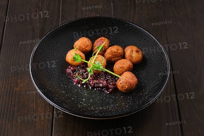 Plate with traditional scandinavian meatballs with cranberry sauce