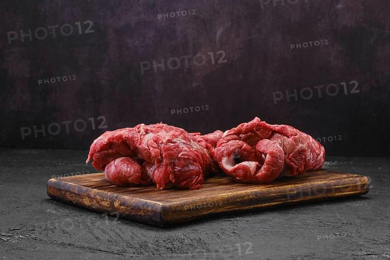 Raw peeled lamb boneless neck meat on cutting board