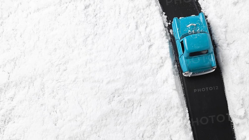 Close up view of blue toy car with snow