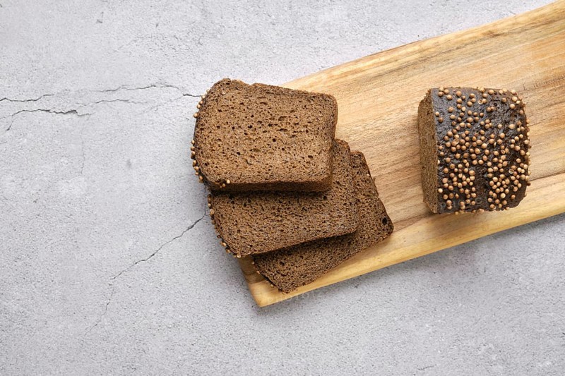 Fresh rye brown bread on wooden cutting board
