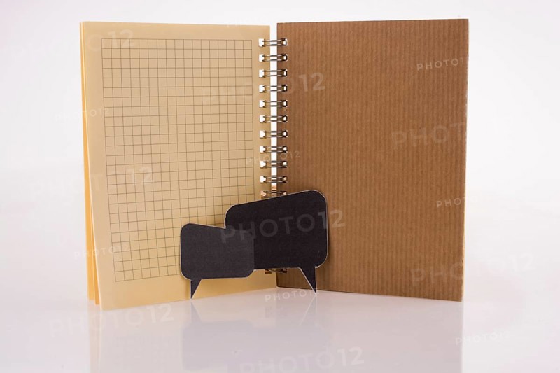 Dialogue boxes near a notebook on a white background