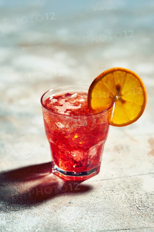 Cocktail boulevardier under sunlight with harsh shadows