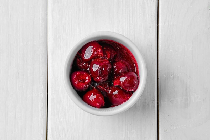 Top view of cherry sauce in ceramic gravy boat