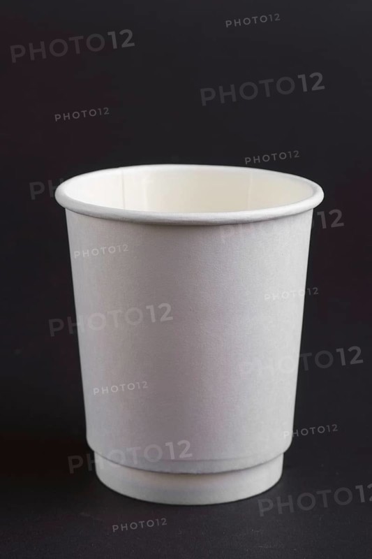 Cardboard cup without lid on dark background
