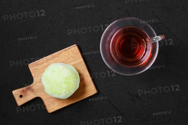Top view of sweet dessert mochi with kiwi with fruit tea