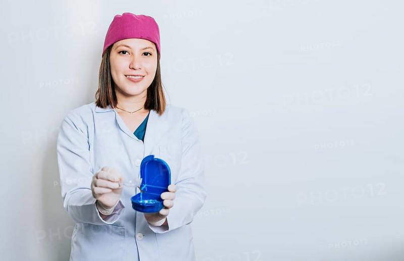 A dentist with retainers on isolated background