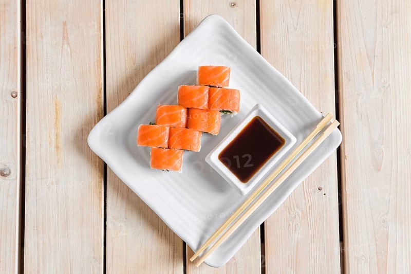 Top view of rolls with trout and chuka salad