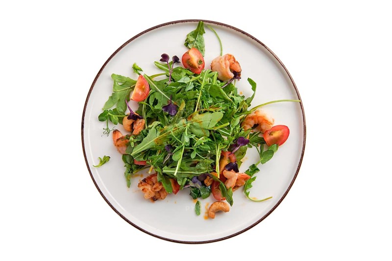 Salad with shrimps and fresh vegetables isolated on white background