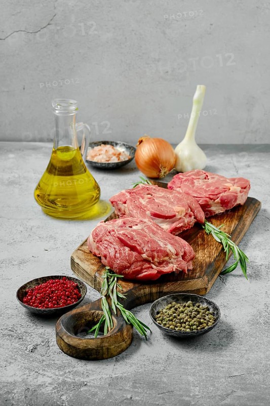 Raw fresh lamb neck cut on slices with spice and herbs