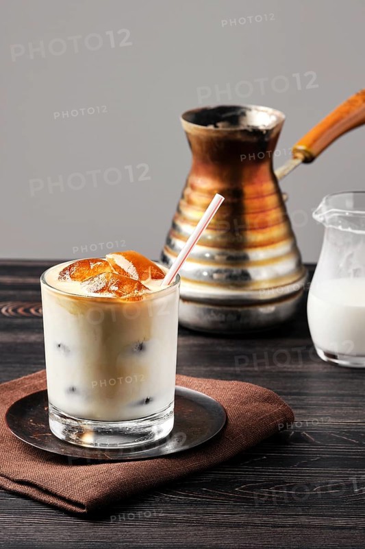 Iced latte with frozen coffee cubes and sweet cream