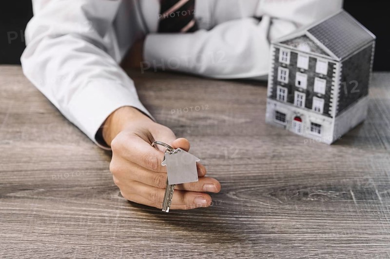 Crop realtor showing new key