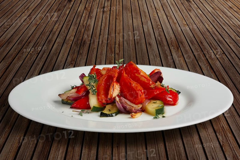 Grilled vegetables on white plate cutted on slices