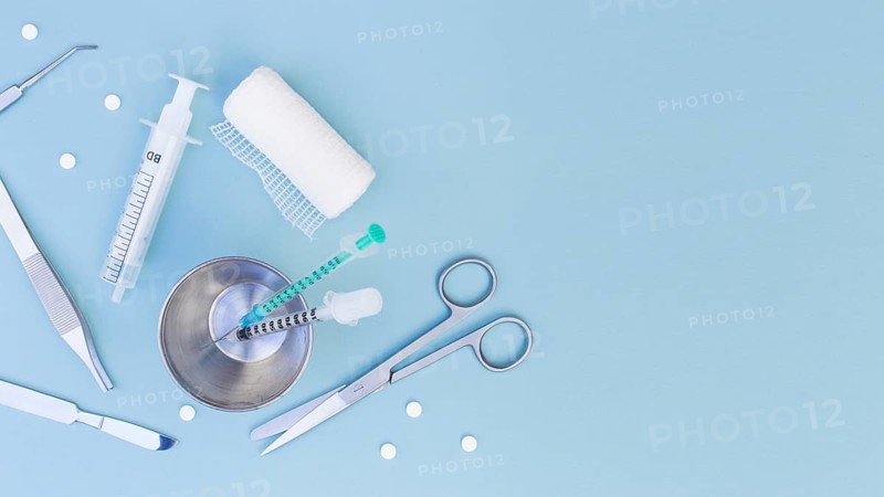 Surgical equipment s syringe glass pills gauze roll blue background. Resolution and high quality beautiful photo