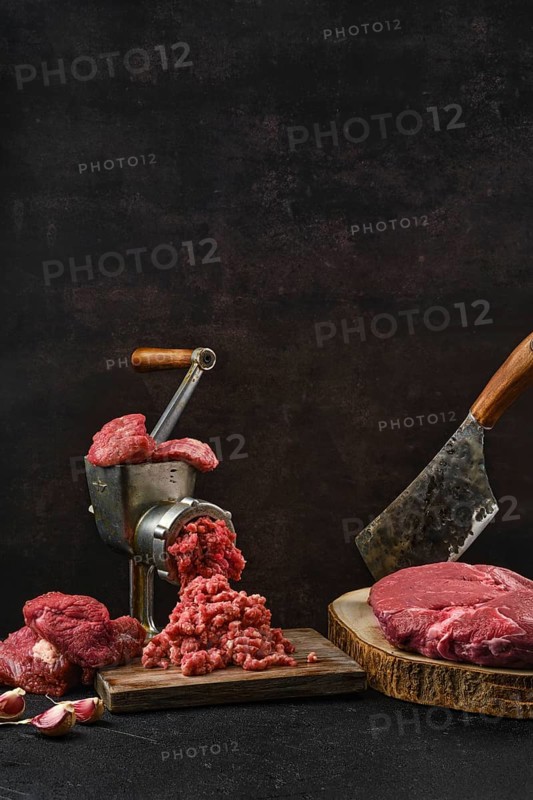 Making minced beef meat with oldfashioned meat grinder
