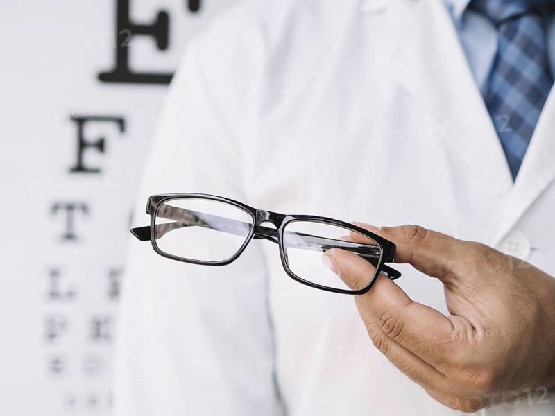 Male doctor holding pair eyeglasses his hands. Resolution and high quality beautiful photo