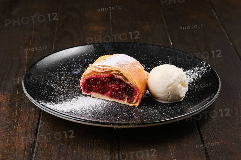 Piece of classic cherry strudel on a plate