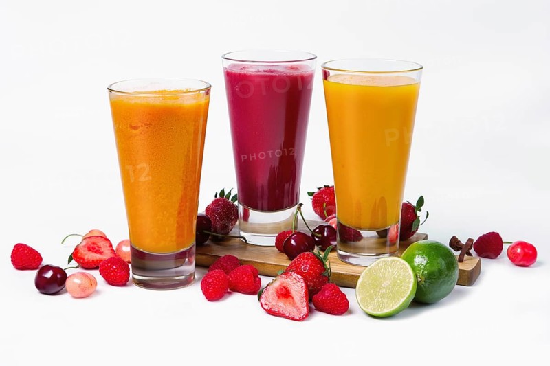 Three glasses with fruit smoothies on white background