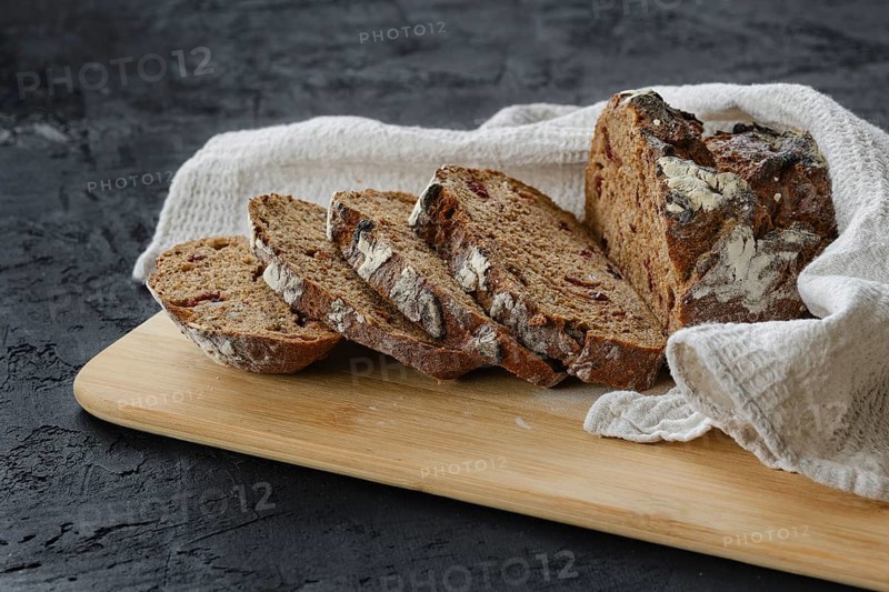 Artisan freshly baked broun bread with raisins cut on slices