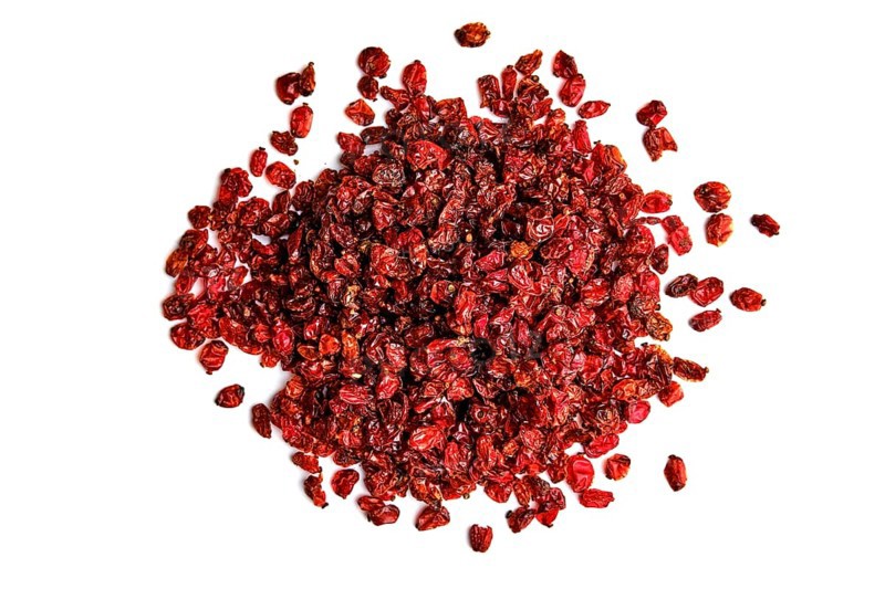 Heap of dry barberry on white background