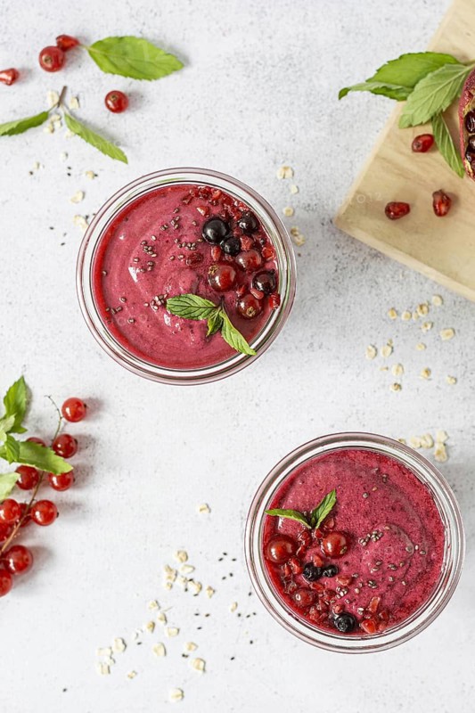 Flat lay smoothie glasses with fruits