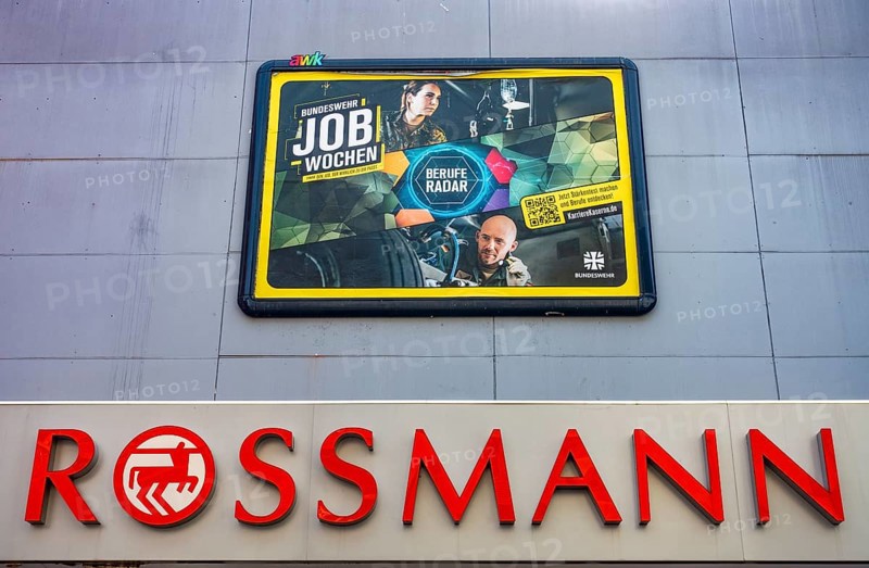 Large poster advertising the Bundeswehr on the wall of a Rossmann shop