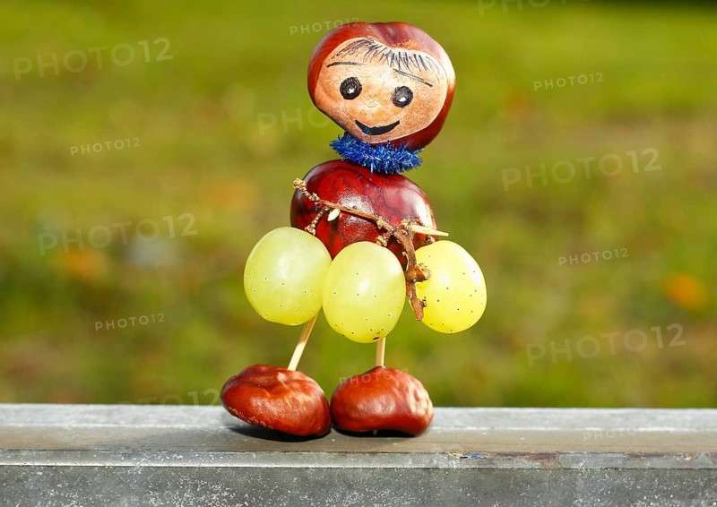 Chestnut figure with grapes in the evening light