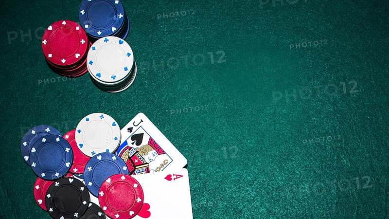 Jack spade heart ace card with casino chips green poker table