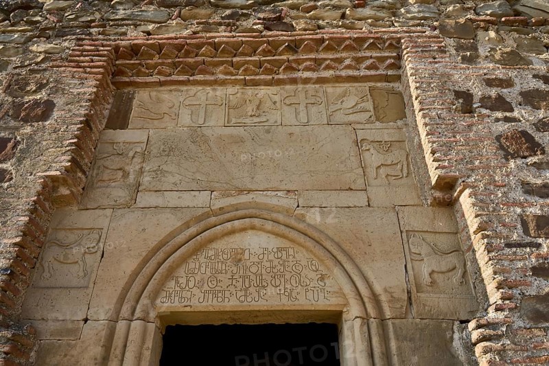 Entrance portal with old Georgian inscription and relief panels with animal motifs