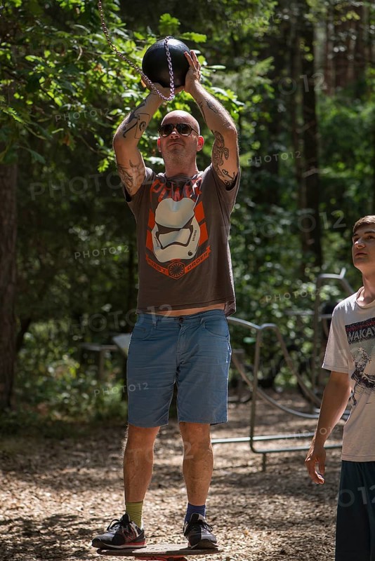 Man playing basketball on a trim trail