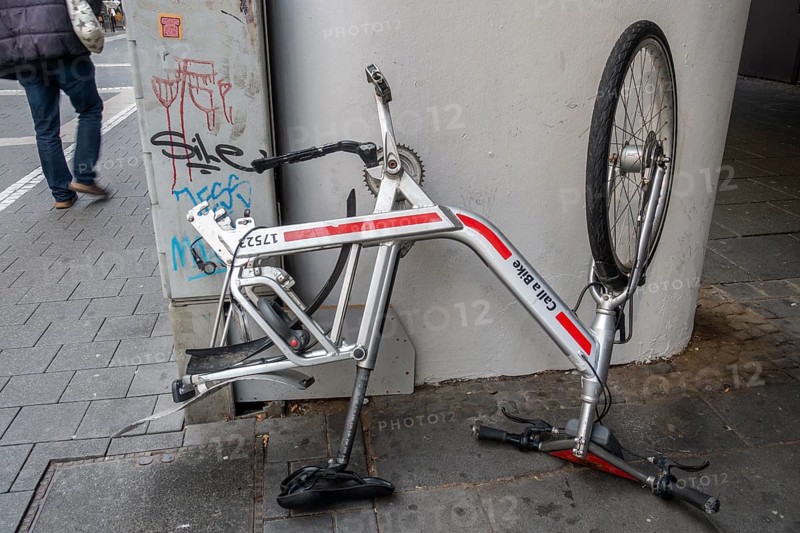 Bicycle standing on handlebars and saddle with dismounted rear wheel from Call a Bike of Deutsche Bahn