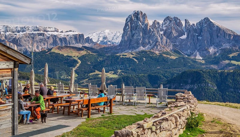 Sun terrace of the Rasciesa Hut on the Rasciesa Alp in front of the Sella Group 3152m