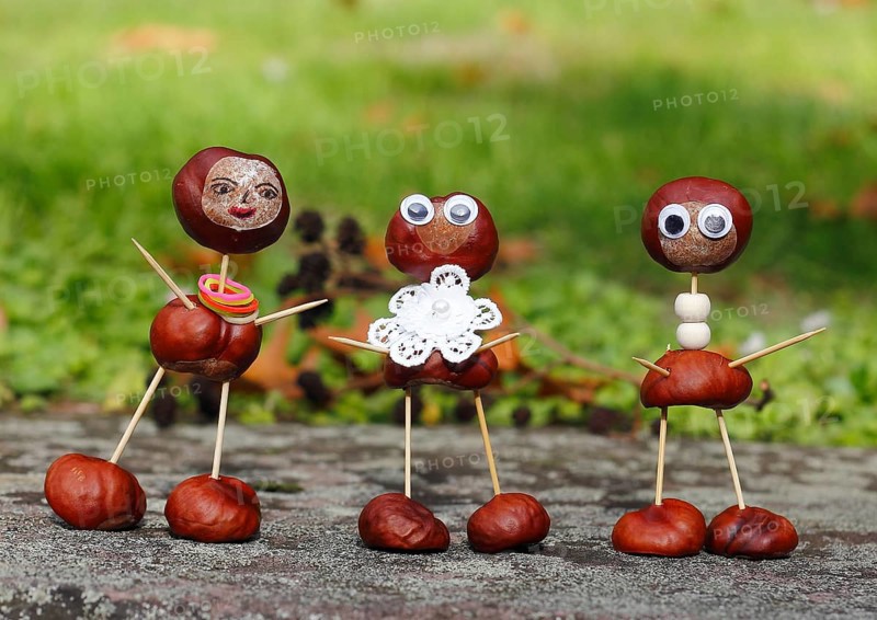 Three funny chestnut figures in the garden