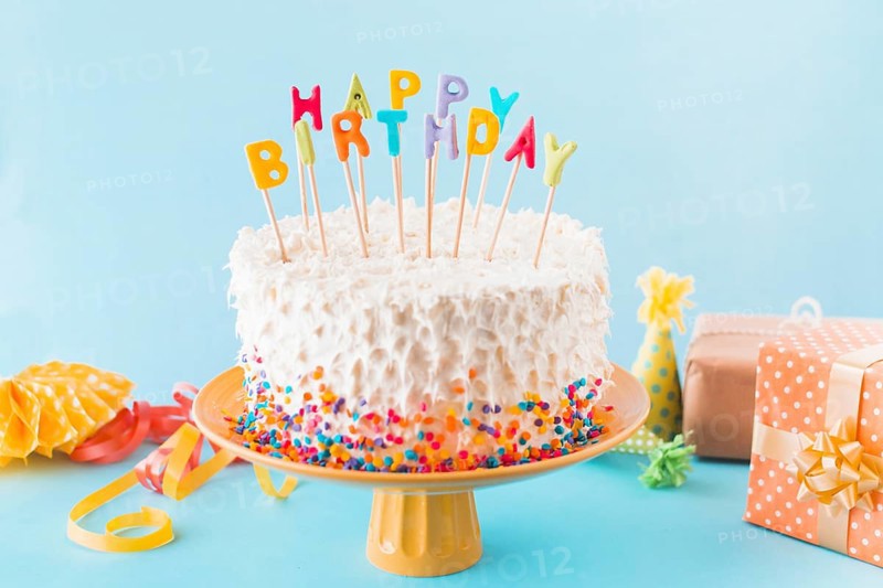 Birthday cake with gift accessories blue background