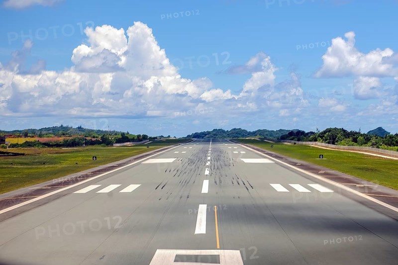 View from cockpit of aircraft on runway landing strip of Palau Koror Roman Tmetuchl International Airport ROR during takeoff