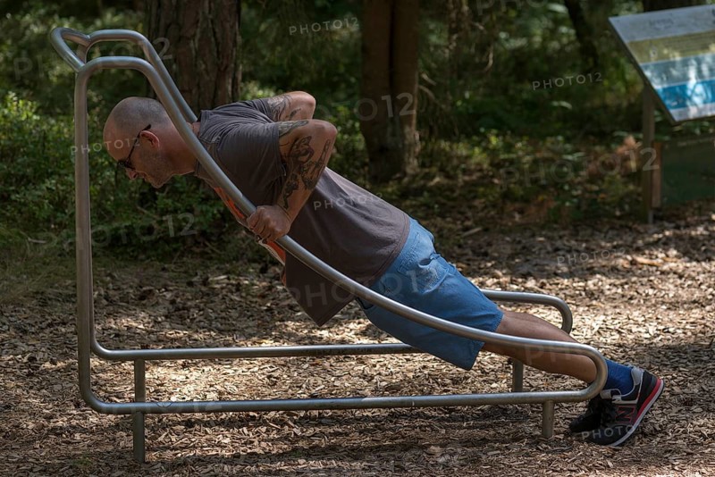 Man doing push-ups on a trim trail