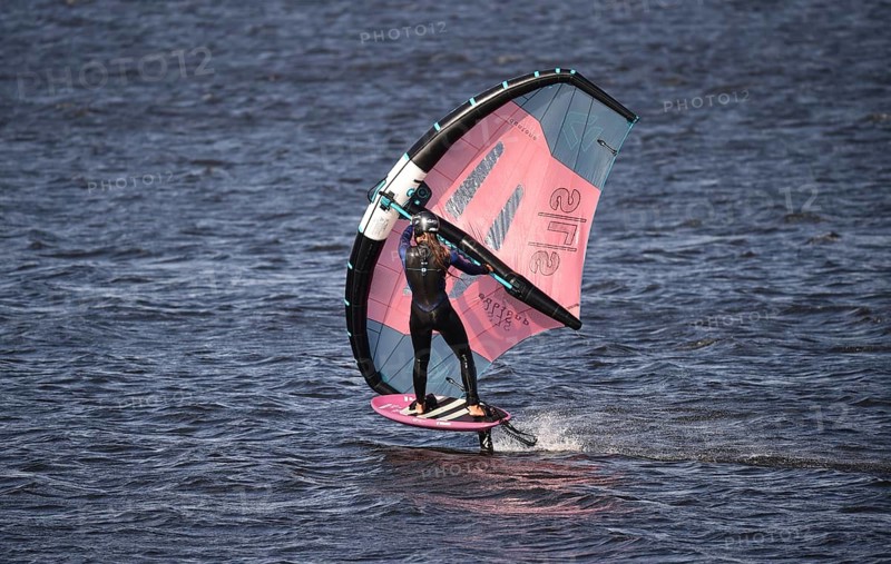 Young woman windsurfing Wingfoil at the North Sea
