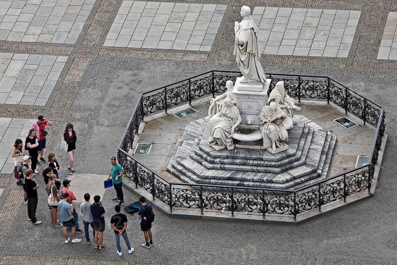 Teacher with group of pupils in front of the Schiller Monument on the Gendarmenmarkt