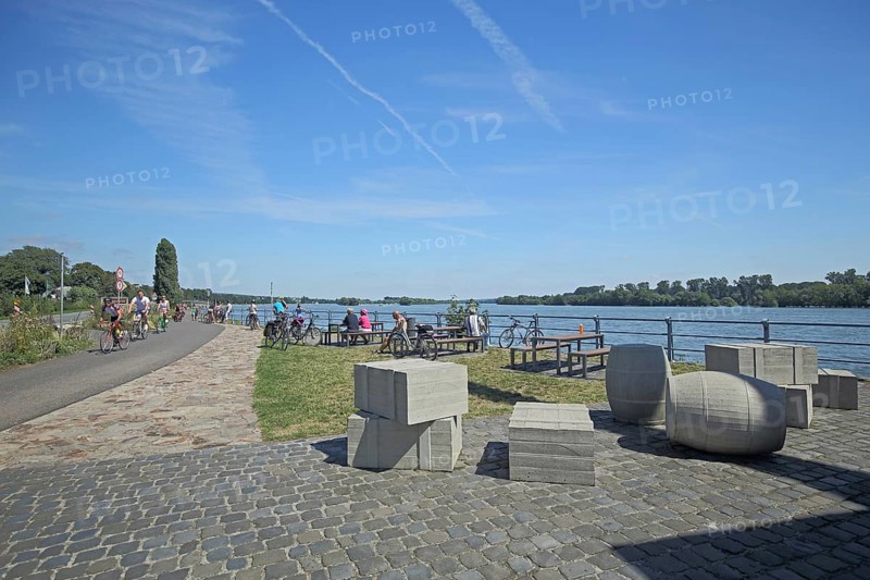 Rest area for cyclists at the wine loading crane on the banks of the Rhine