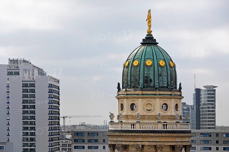The domed tower of the German Cathedral at Gendarmenmarkt in front of newly built skyscrapers