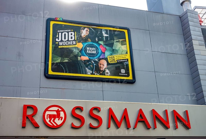 Large poster advertising the Bundeswehr on the wall of a Rossmann shop