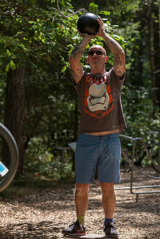 Man playing basketball on a trim trail