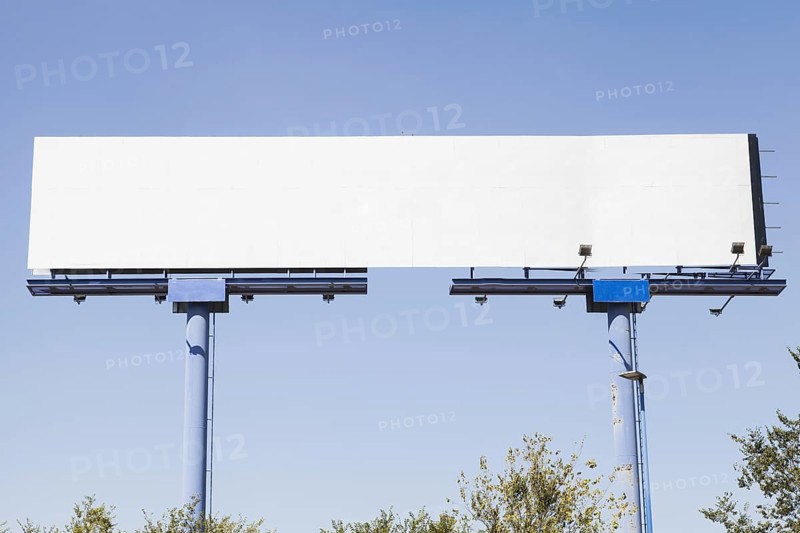 Big blank advertising hoarding against blue background