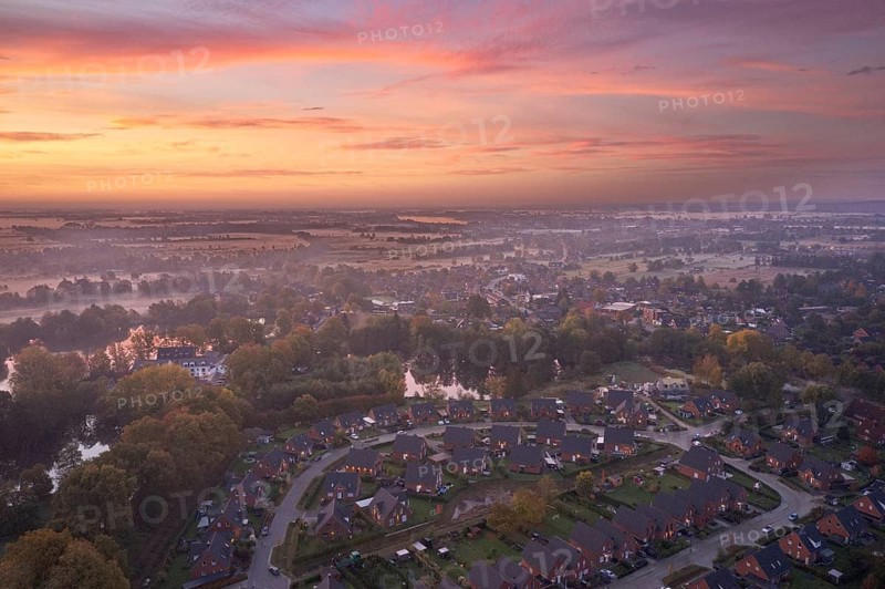 Aerial view of the landscape around Sandbraak Lake near Fuenfhausen in Hamburg's Kirchwerder district in autumnal morning atmosphere with light ground fog. In the foreground the residential area Fritz-Bringmann-Ring
