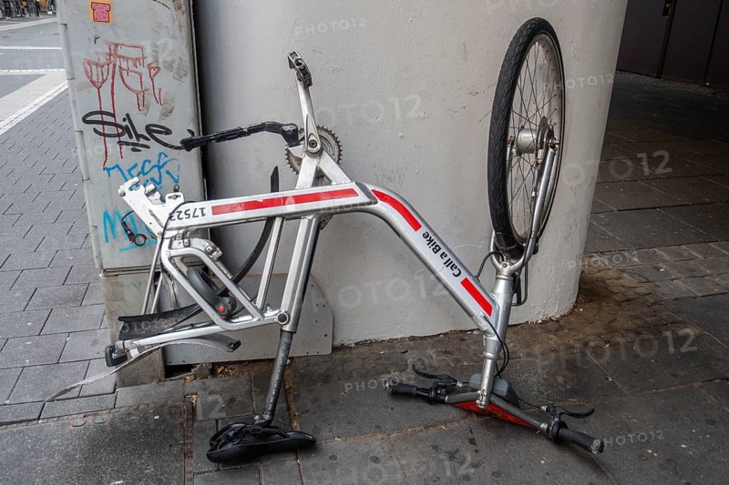 Bicycle standing on handlebars and saddle with dismounted rear wheel from Call a Bike of Deutsche Bahn