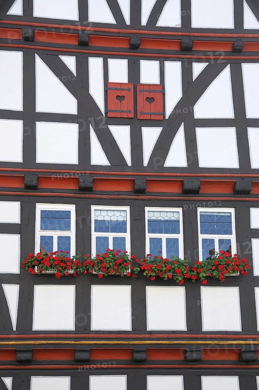 Idyllic house wall with shutters and flower decoration from the historic town hall